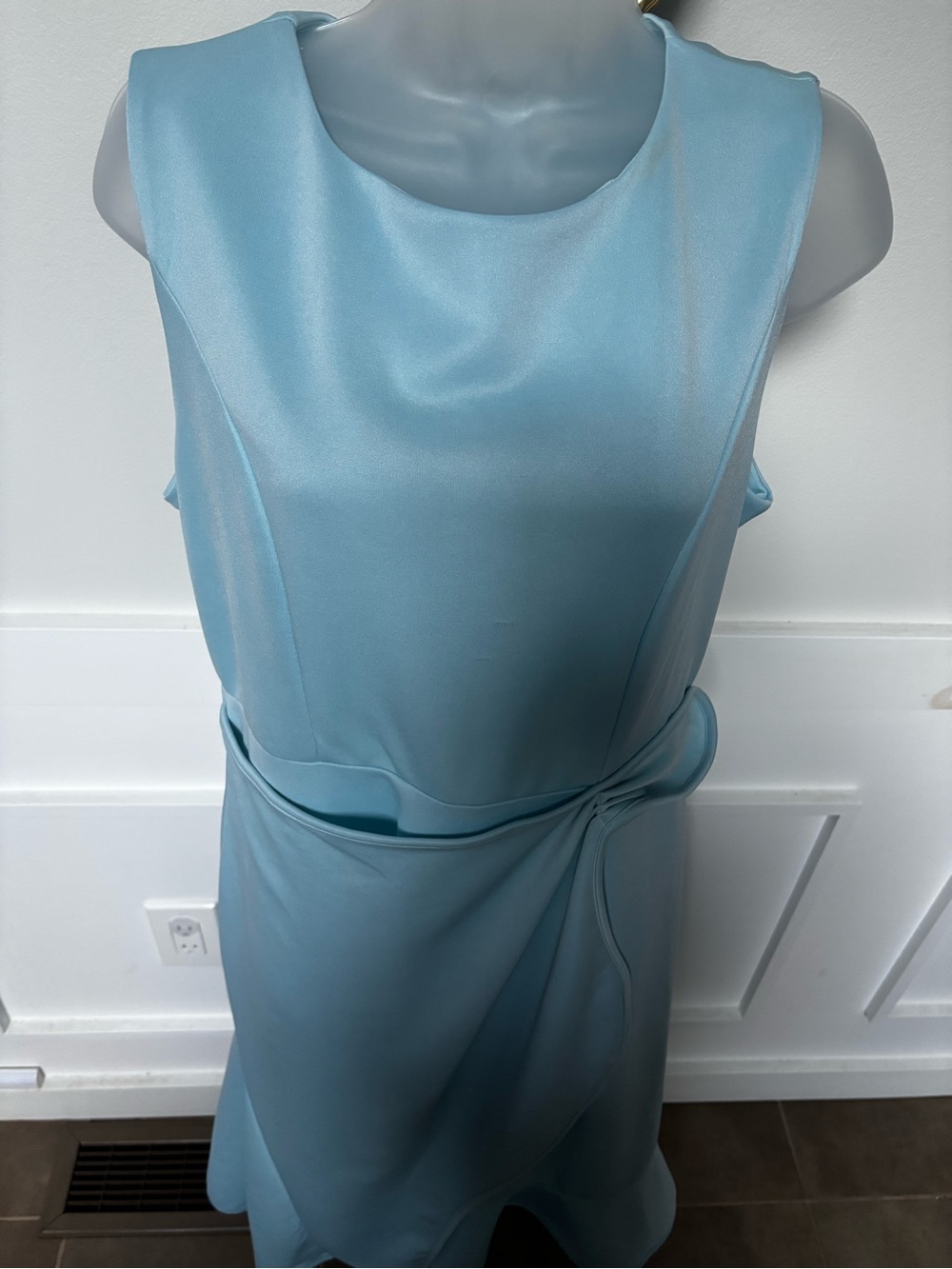 light blue sleeveless midi dress featuring a rounded neckline, a draped twist
